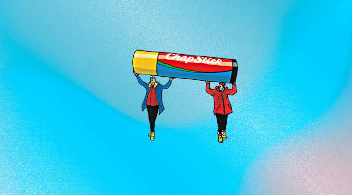 Illustration of two people holding up a tube of chapstick